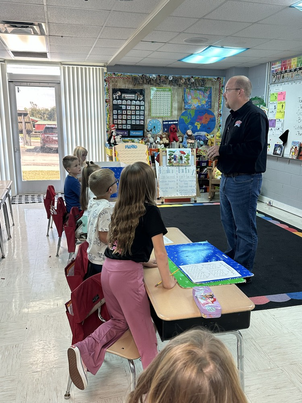 Mr. Gray visiting first grade for National bubble gum day 