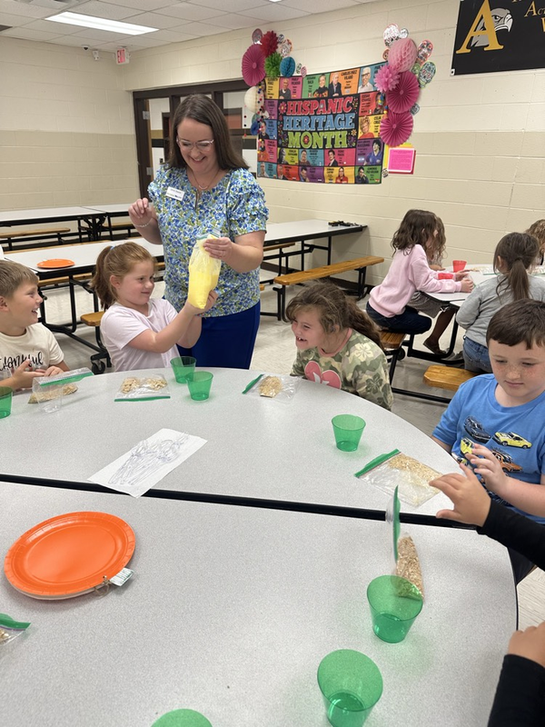 first grade students helping make the pie filling