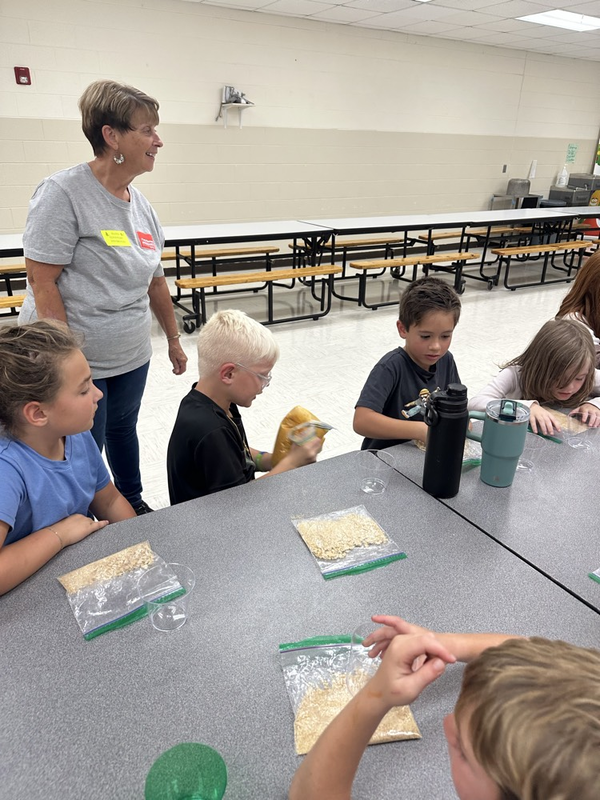 first graders helping make the pie filling