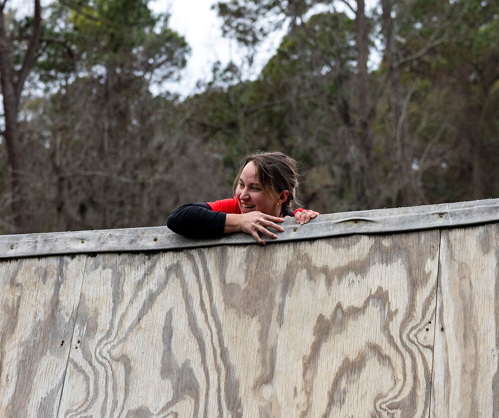 teacher climbing over wall