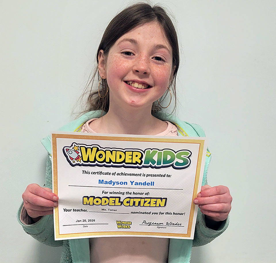 Wonder Kids award winner holds certificate