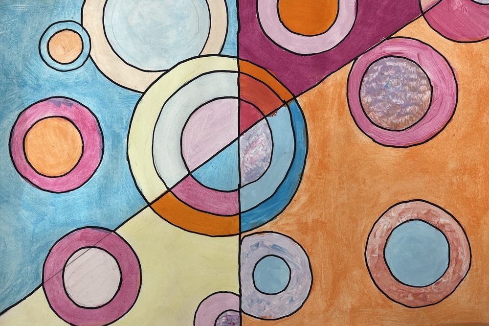 Concentric circles in pastel shades fill a colorful  geometric background