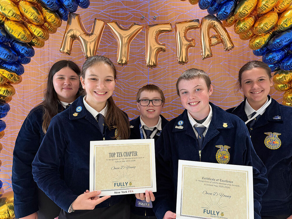 FFA students stand together as a group, hold award certificates