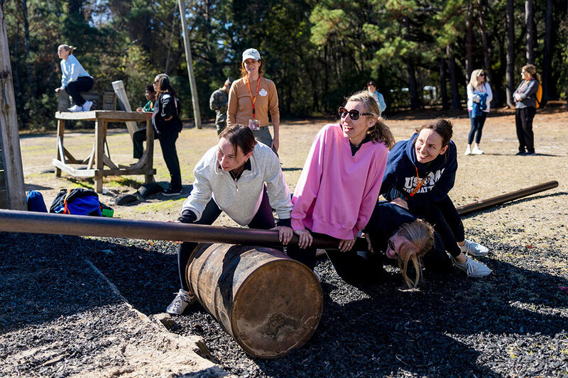 Three teachers work together as a team on a Marine Corps challenge