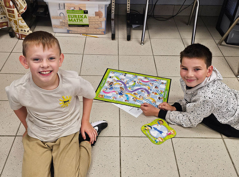 two students play a board game