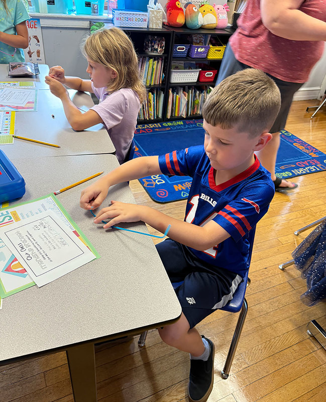 Student works to build bracelet