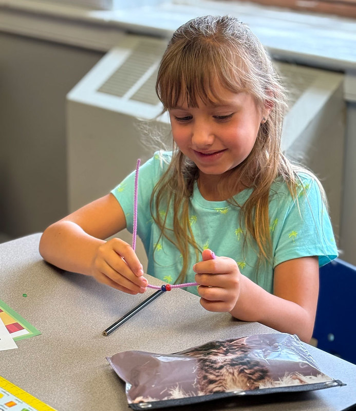 Student works to build bracelet