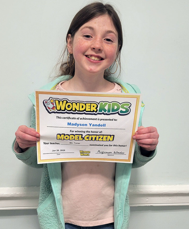 Wonder Kids award winner holds certificate