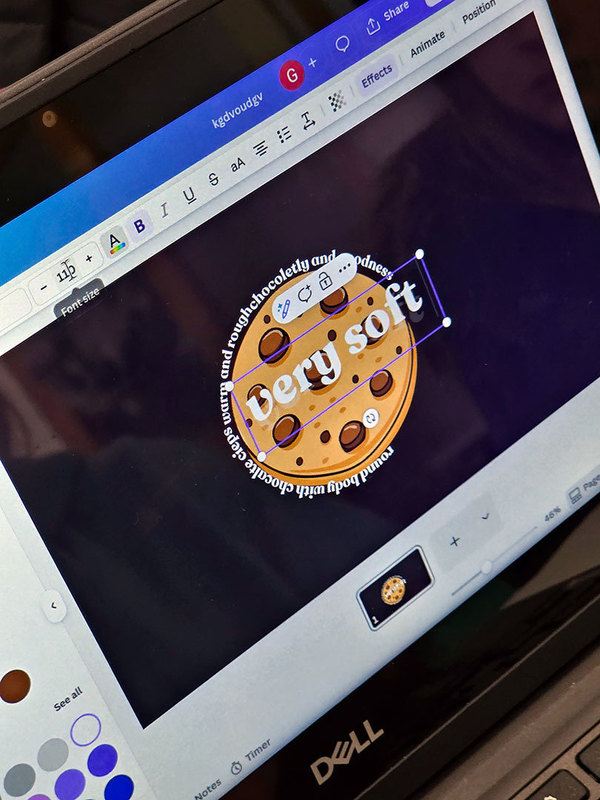 words encircle the image of a chocolate chip cookie on the screen of a laptop