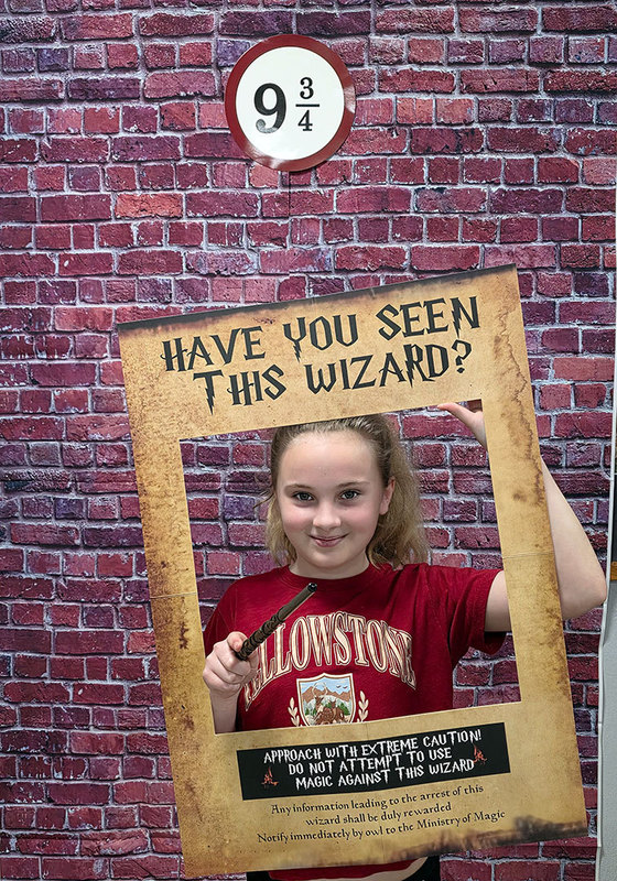 A student holds a photo booth prop 
