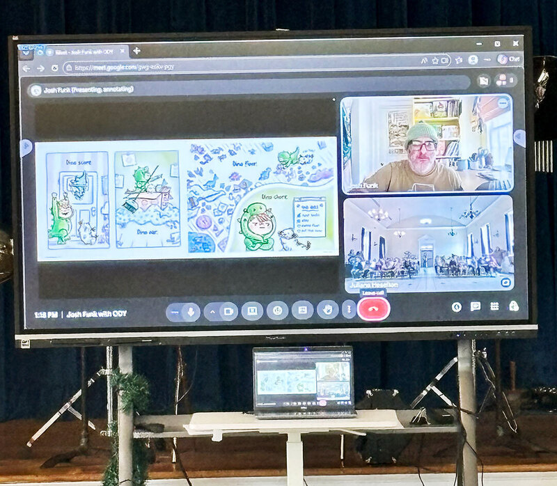 author appears on screen at the front of the room