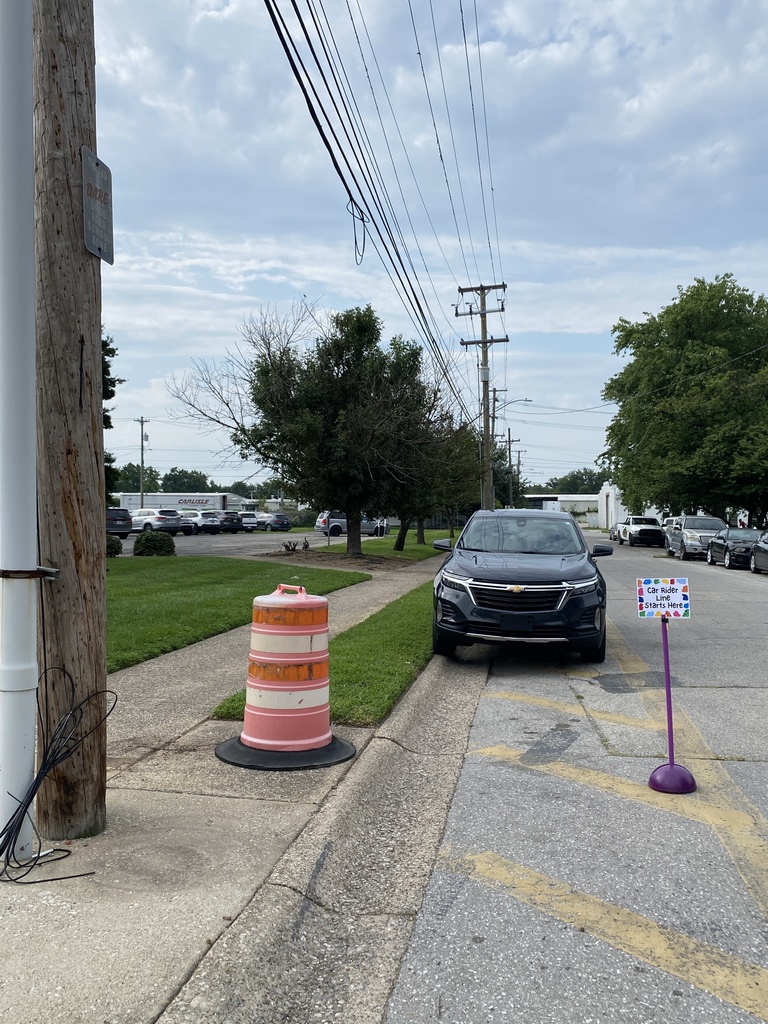 Start car rider line at electric pole/orange cone
