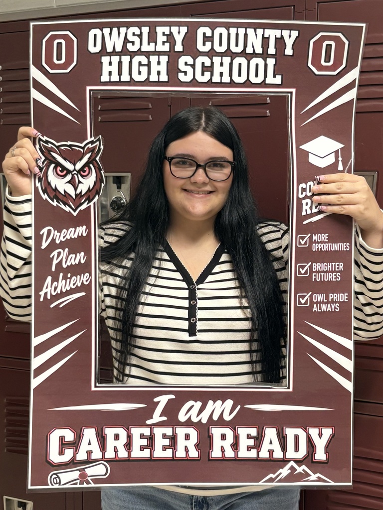 A student holds up a frame to celebrate being deemed career ready.