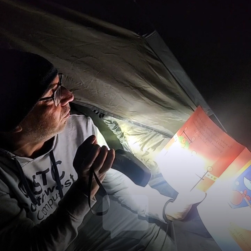 Mr. Kaye Reading in a Tent