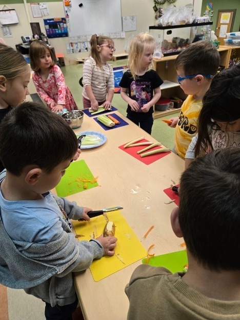 Children cutting up vegetables