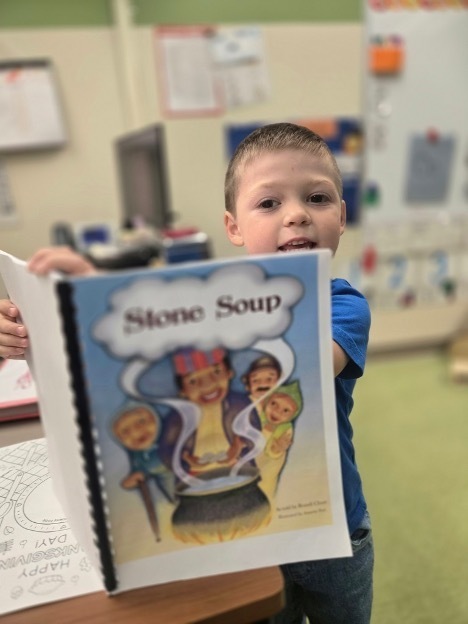 Boy holding Stone Soup book