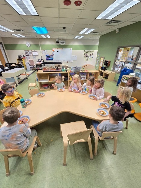Table of children eating soup
