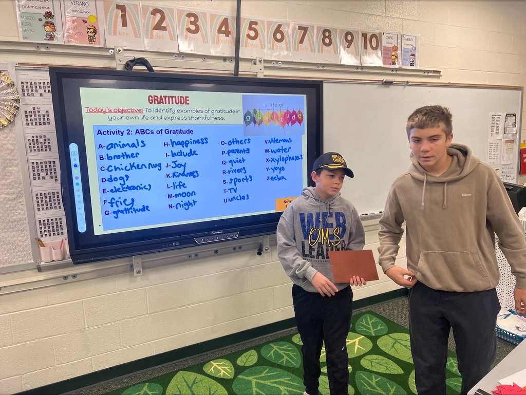 middle school students with decorated paper leaves