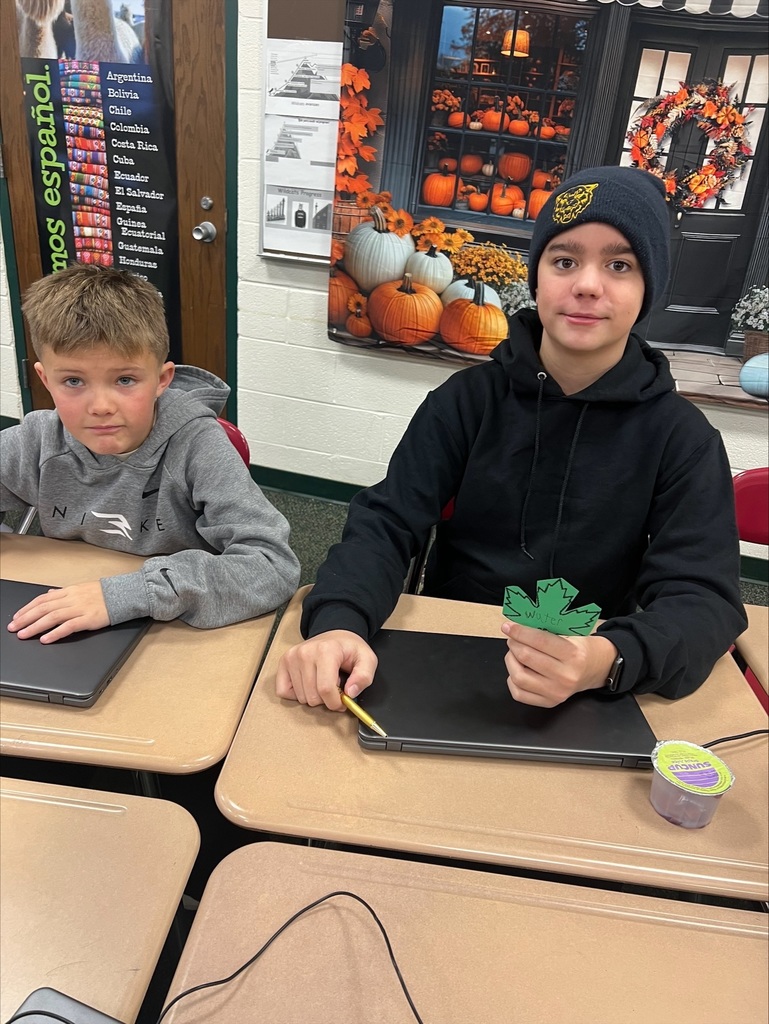 middle school students with decorated paper leaves