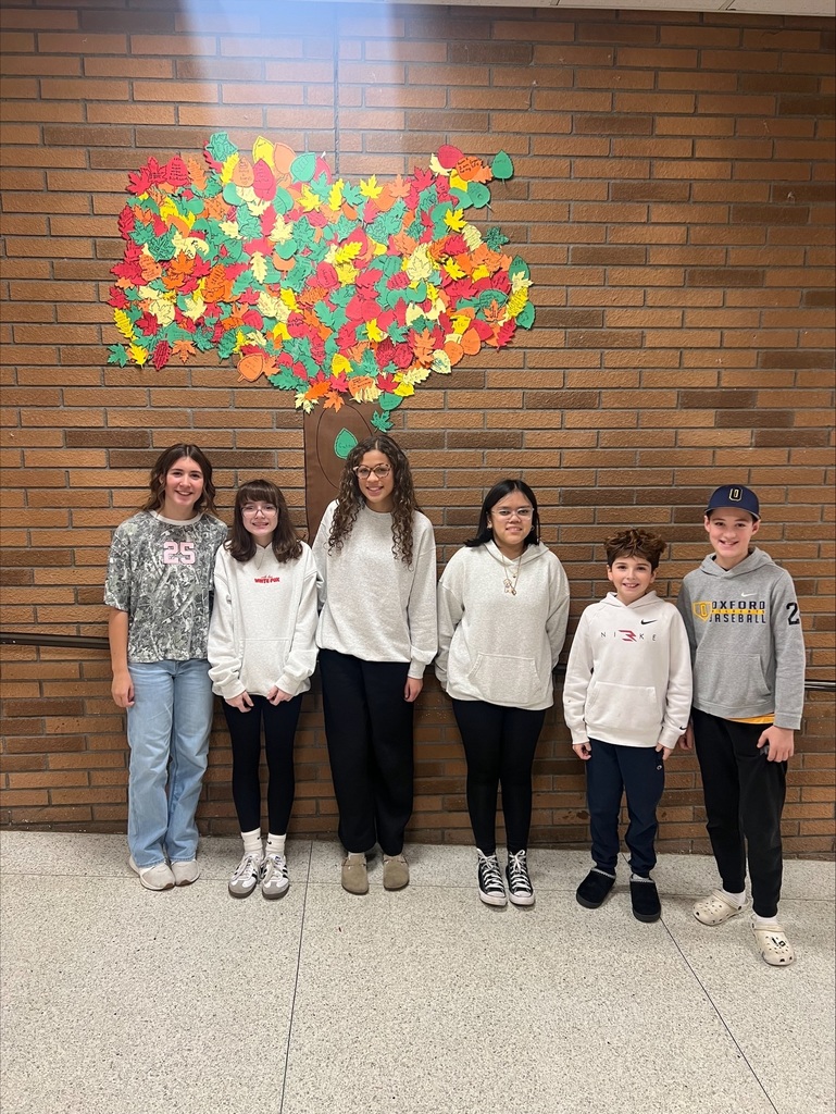 middle school students with decorated paper leaves