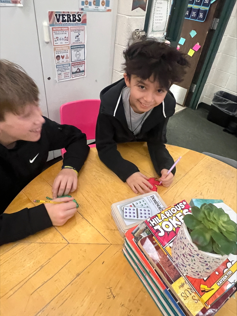 middle school students with decorated paper leaves