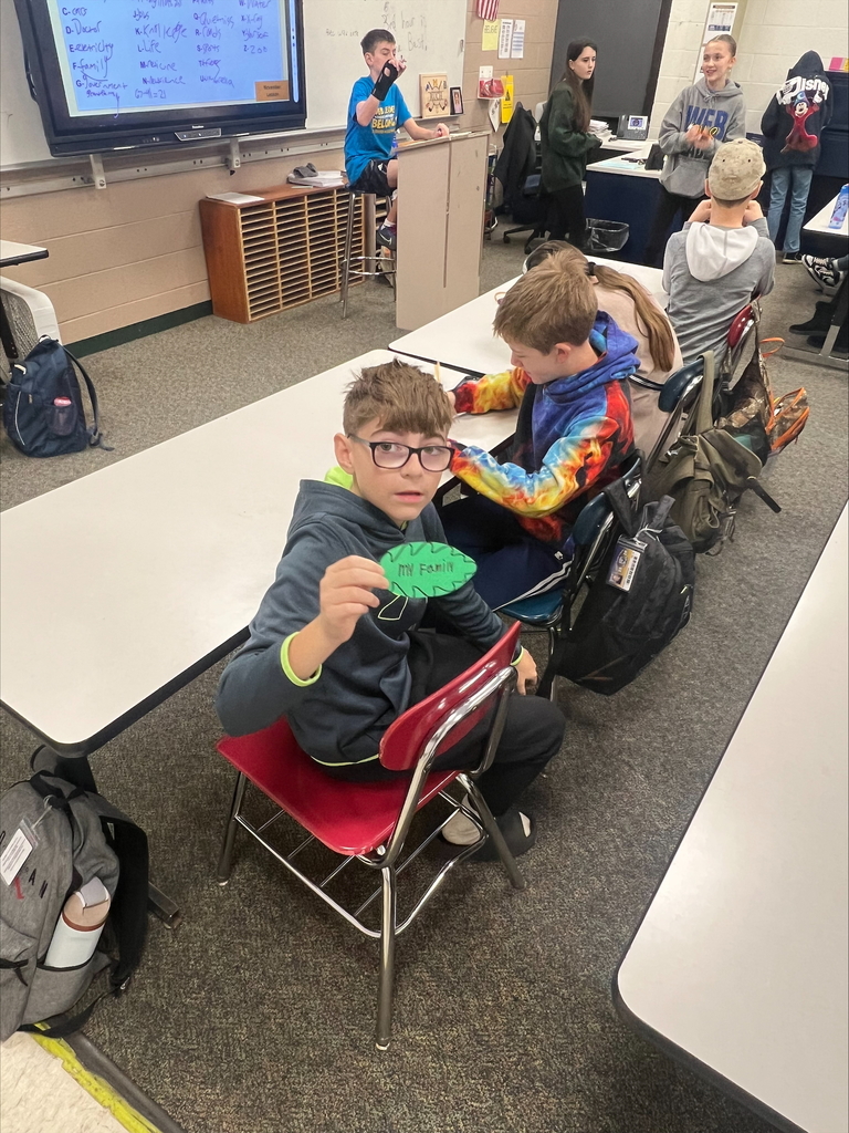 middle school students with decorated paper leaves