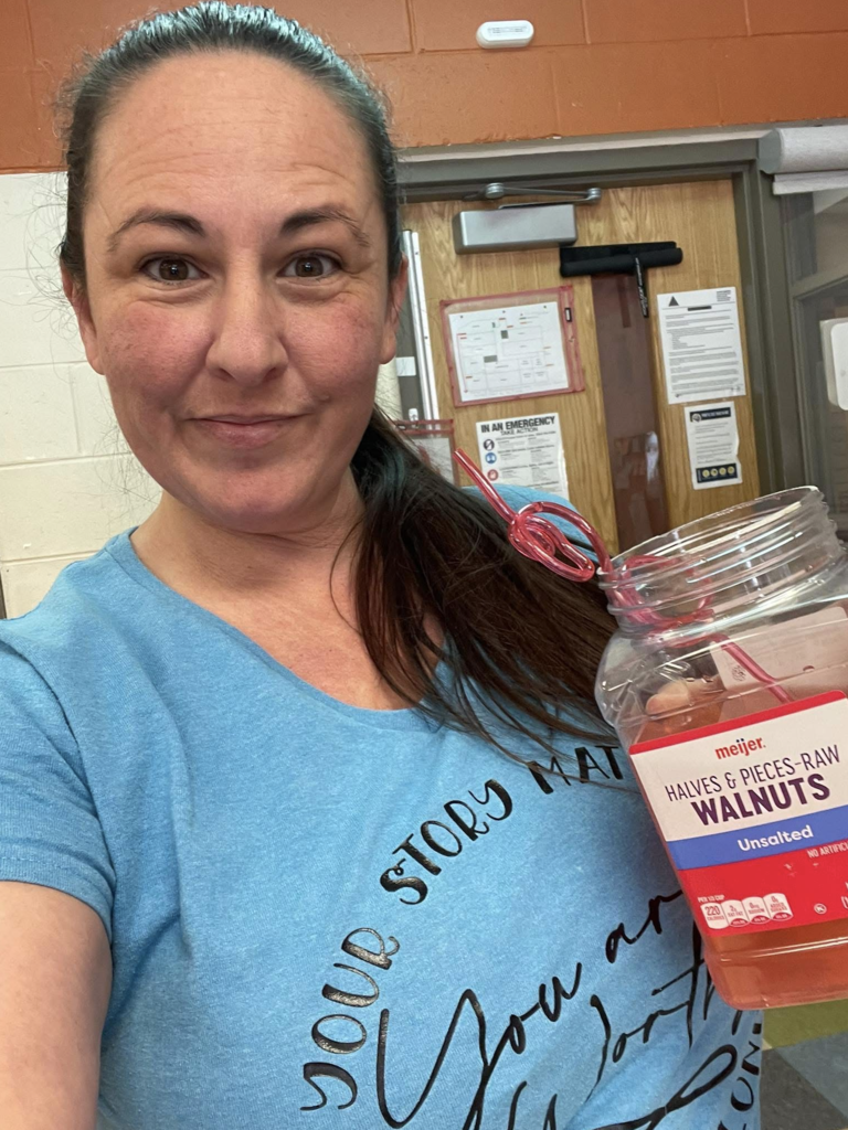 OELC staff holding up a drink in a random item