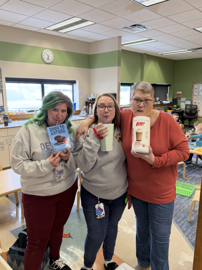 OELC staff holding up drinks in random items 