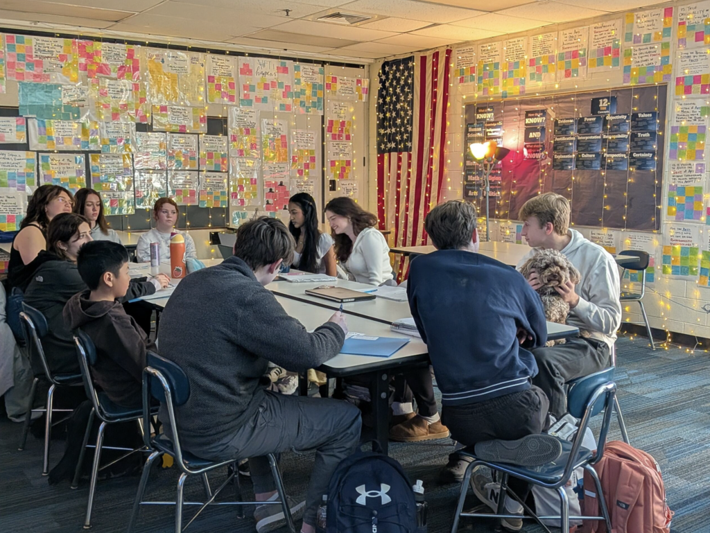 Students working at a desk in a group