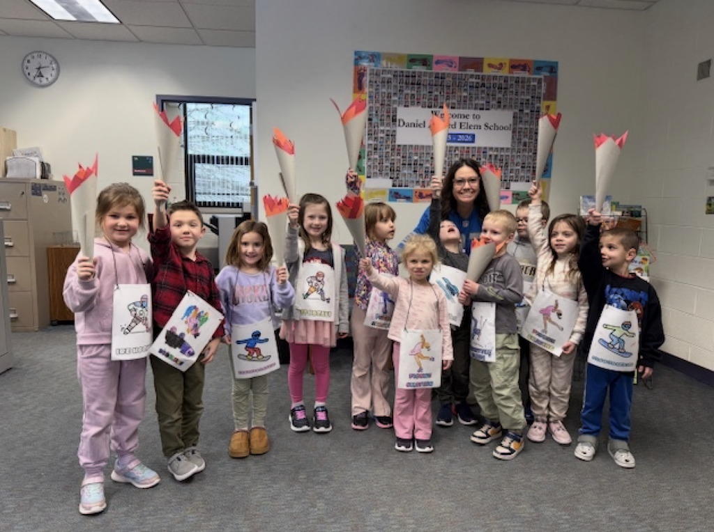 Students holding up paper olympic torches