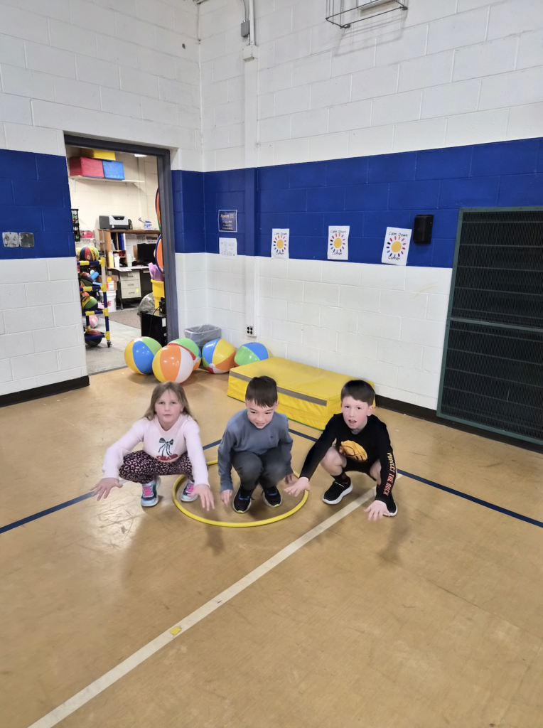 kids sitting in a hula hoop