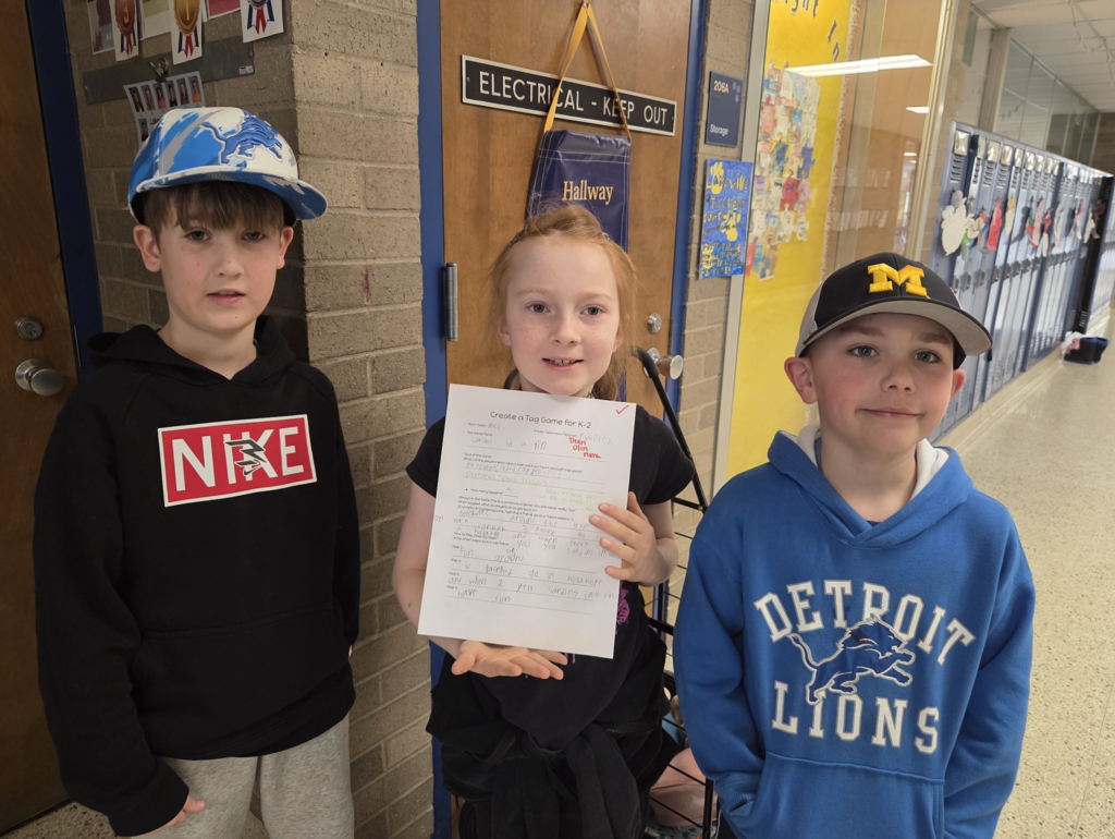 kids holding up paper