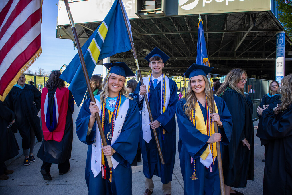 Three students carrying flags