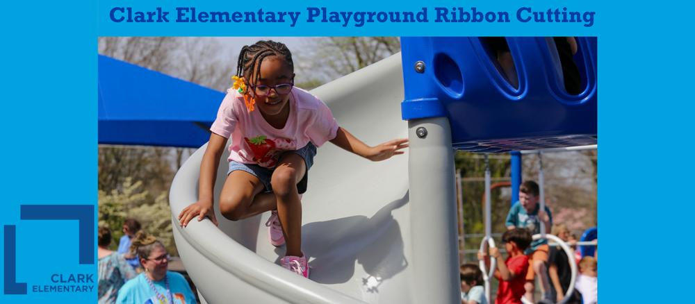 A girl goes down a slide on a playground