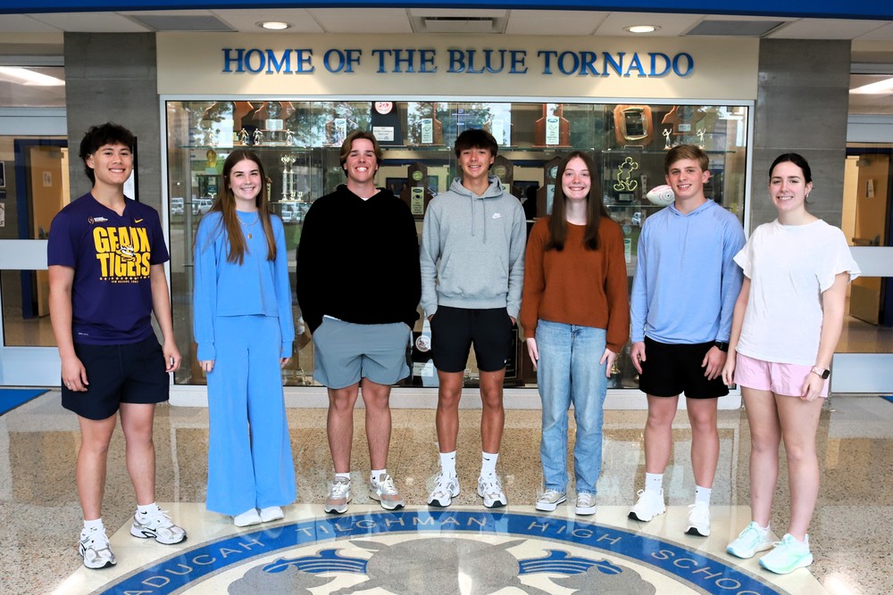 Students pose in a high school lobby