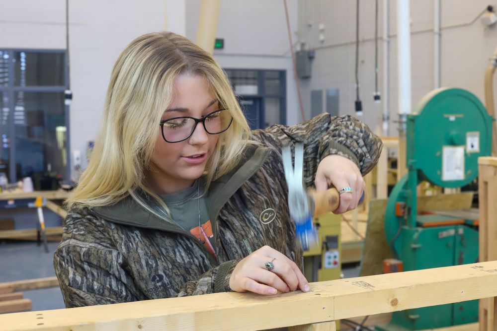 student hammering a nail