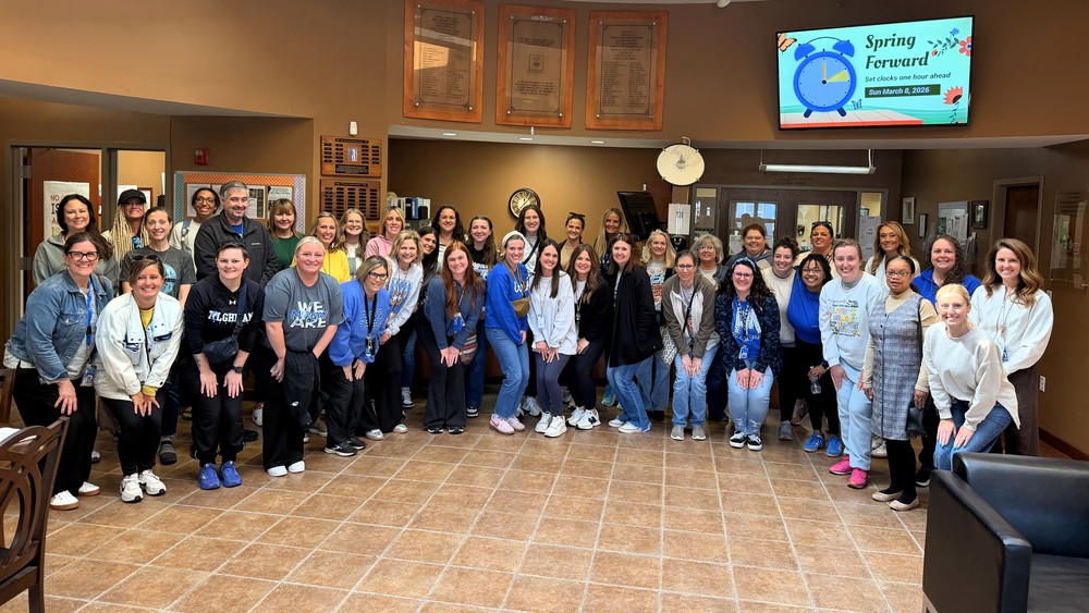Image of a group of teachers standing in a lobby