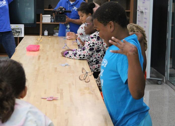 A group of students make 3D printed butterflies