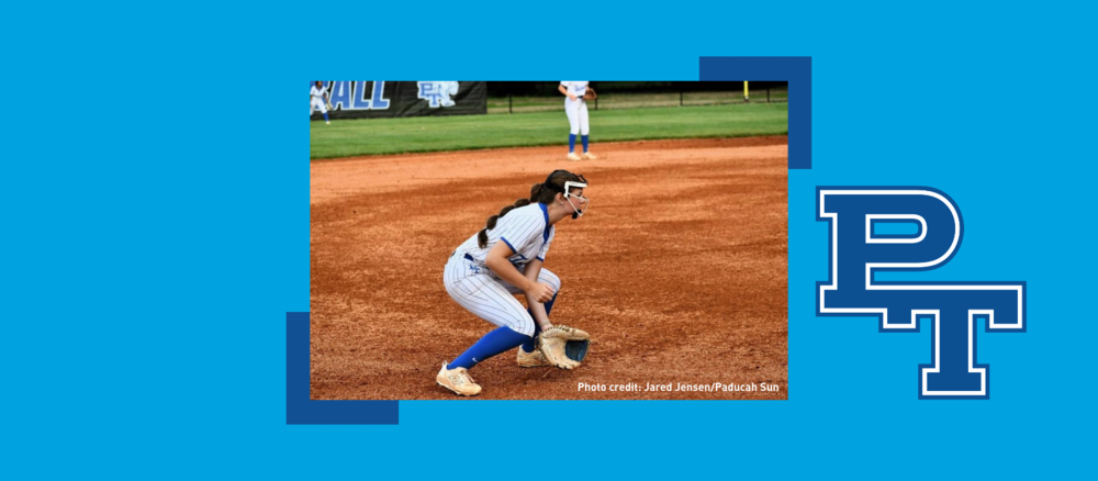 A softball player prepares to catch a ground ball