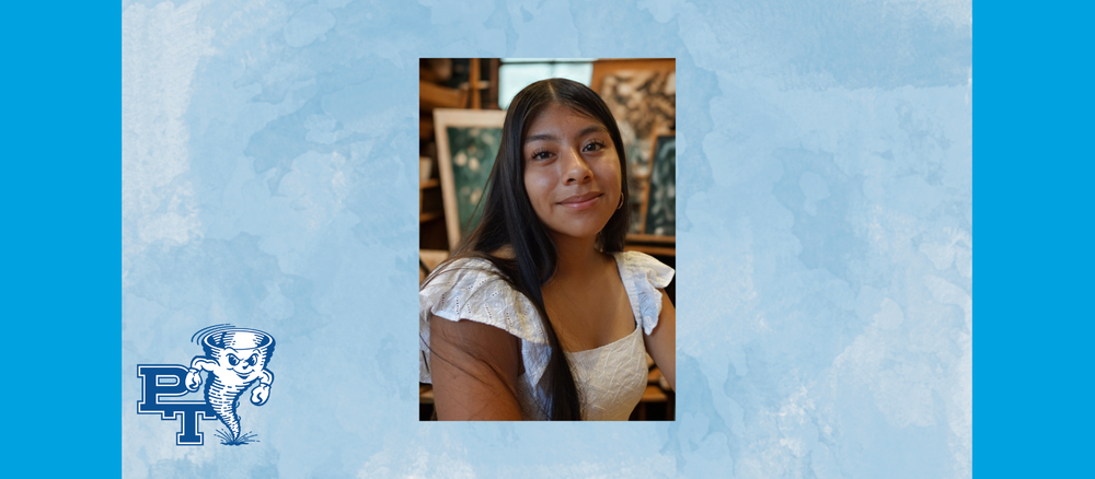 A student in an art studio looks at the camera