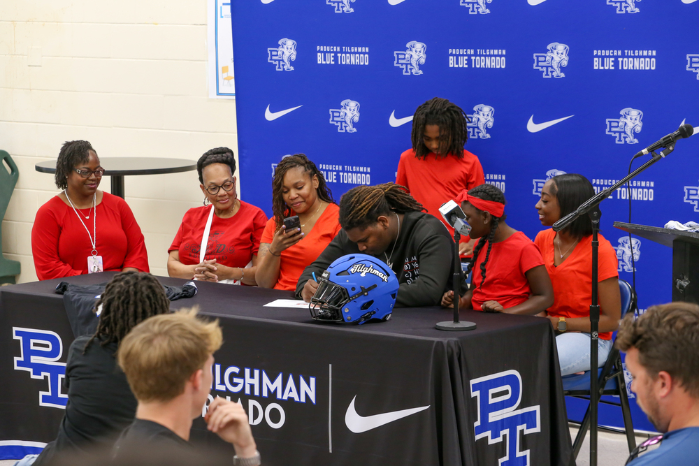 A students signs a scholarship