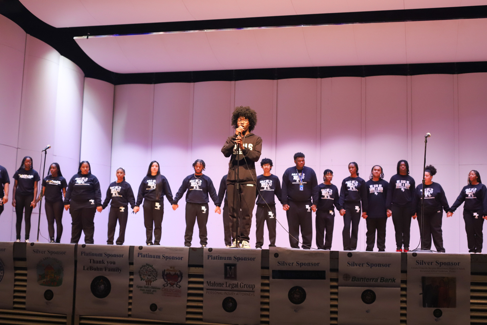A group of sudents stand on a stage
