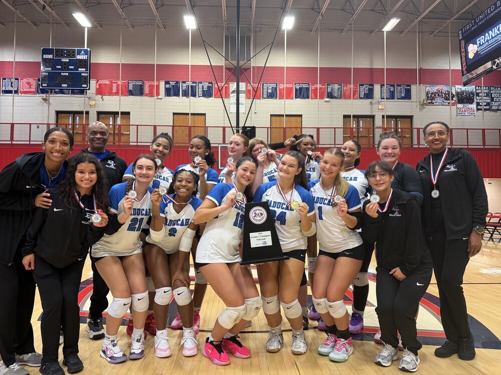 A volleyball team with trophies and medals