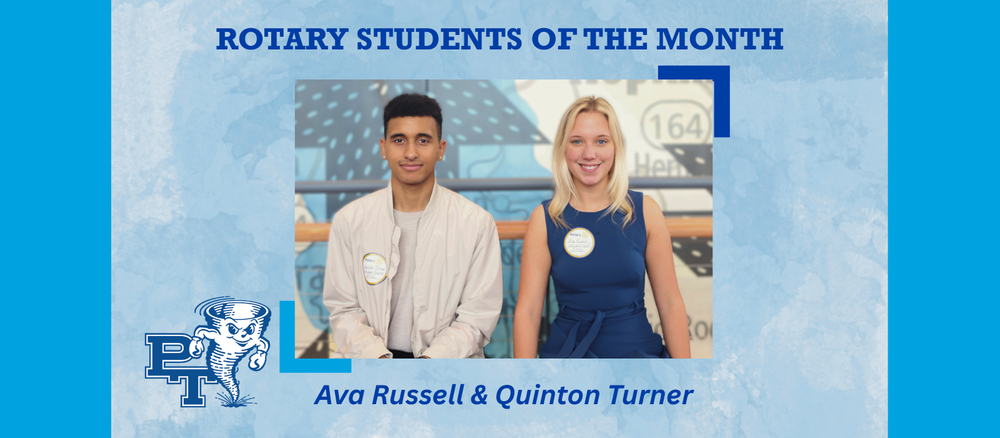 two students sit on a bench in front of a quilt mural