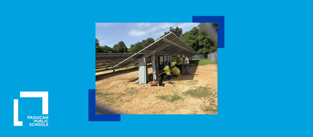 laborers work on a solar field panel