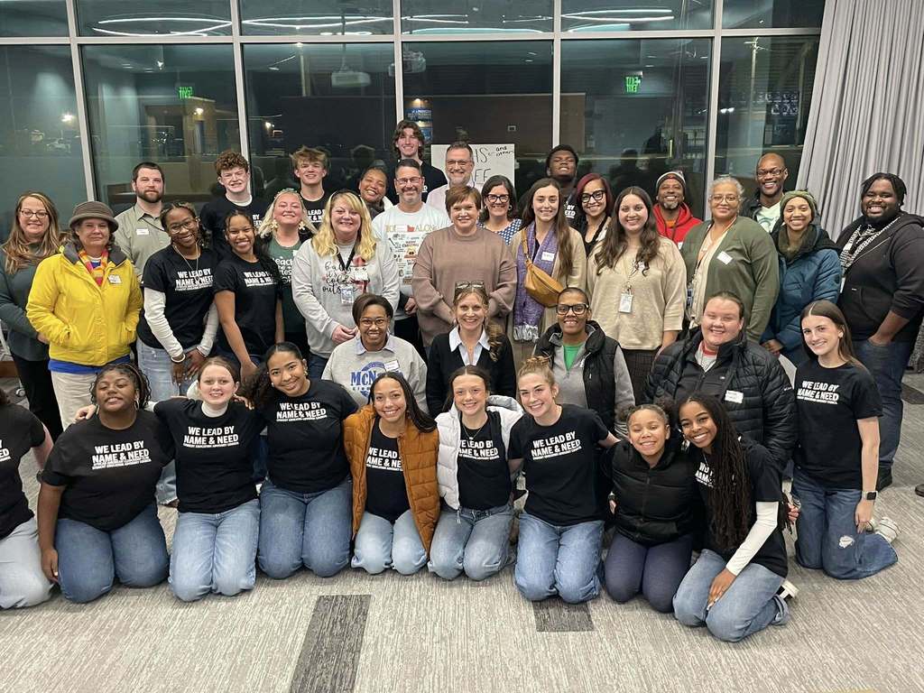 A group of students and staff smiling