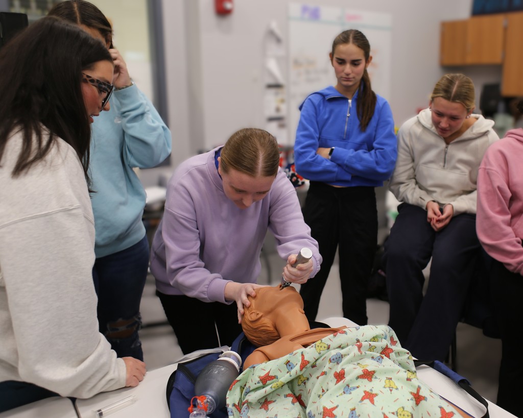 a student practicing intubation on a dummy