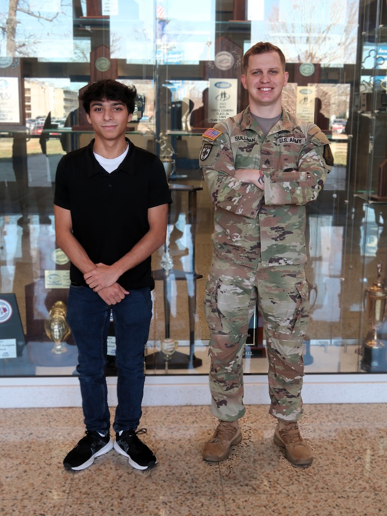a student and national guardsman standing together