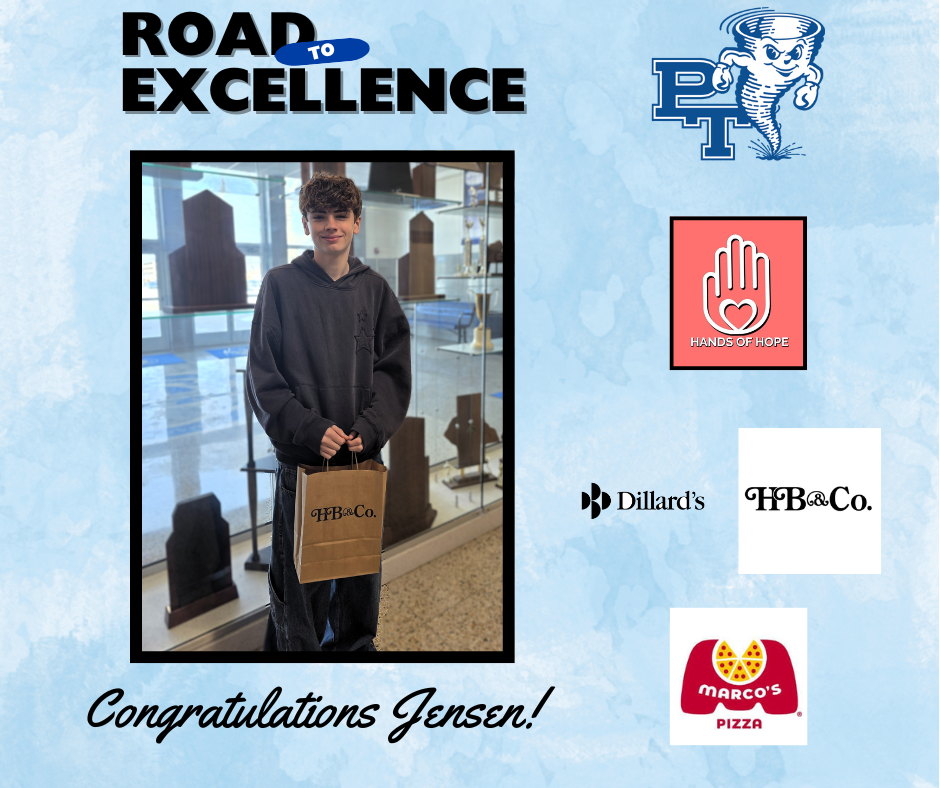 A person holding a brown bag stands in front of a glass display. Logos of Road to Excellence, PT, and sponsors are around.