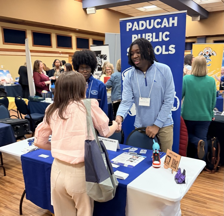 A teenager speaking to a woman.